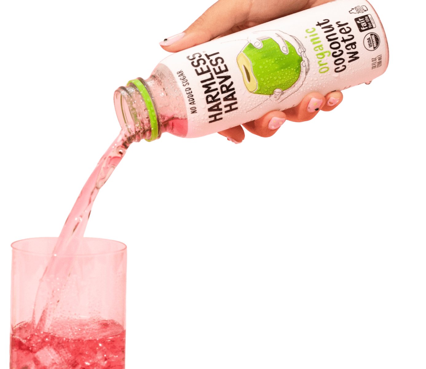 Hand pouring Organic Coconut Water into glass