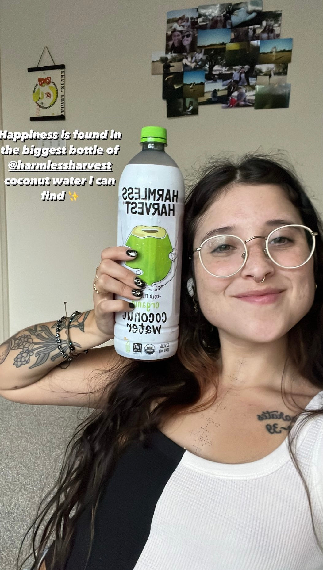 Woman with dark hair and glasses holding Harmless Harvest Organic Coconut Water. Caption: Happiness is found in the biggest bottle of @harmlessharvest coconut water I can find.