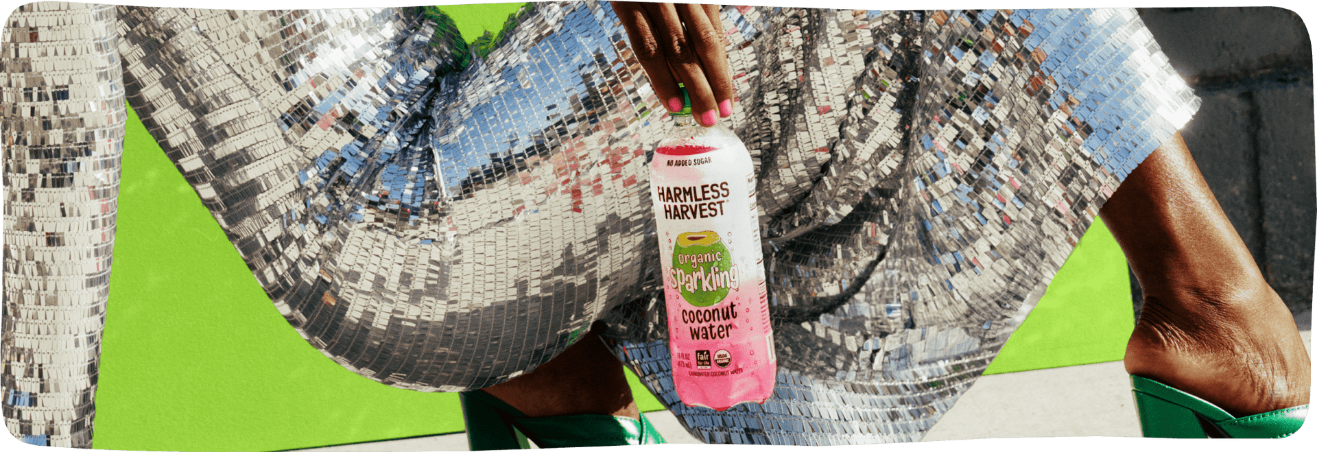 Hand holding Harmless Harvest Coconut water
